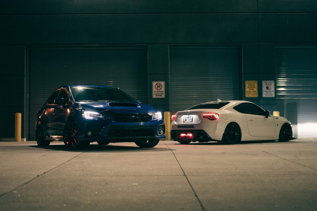 two sports cars parked tonight